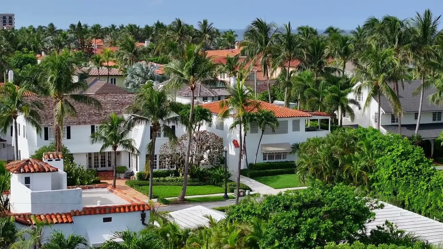 An aerial view of homes and landscaped streets in a residential neighborhood